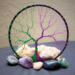 purple and green wire create this magical and mystical tree of life wrapped in black cotton yarn 